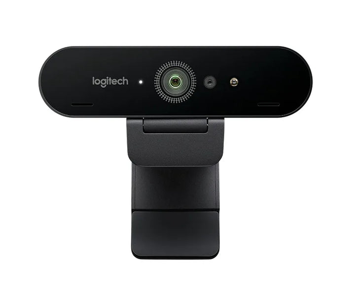 Introducing the Home Office Space NZ Logitech BRIO Ultra HD Webcam, featuring a sleek, black rectangular design mounted on a stand. The centrally located camera lens is surrounded by an LED light ring and flanked by noise-canceling microphones, delivering stunning 4K Ultra HD video quality.