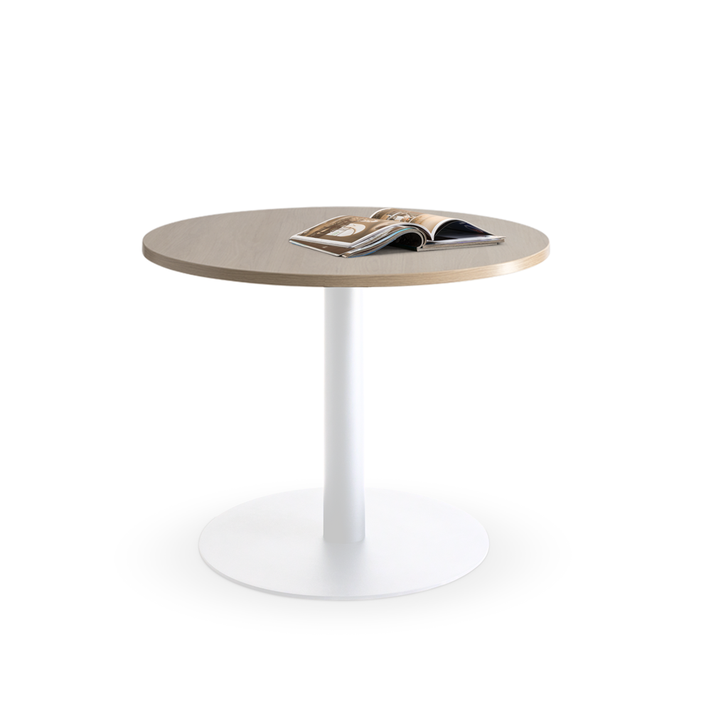 Standing elegantly in an office setting, the Lunar 900 Meeting Table by Home Office Space NZ features a round wooden top and a white metal pedestal base. An open magazine displaying colorful pages rests on the table, enhancing its inviting appeal. Perfect for a home office space, this durable meeting table blends style and functionality seamlessly against a plain white background.