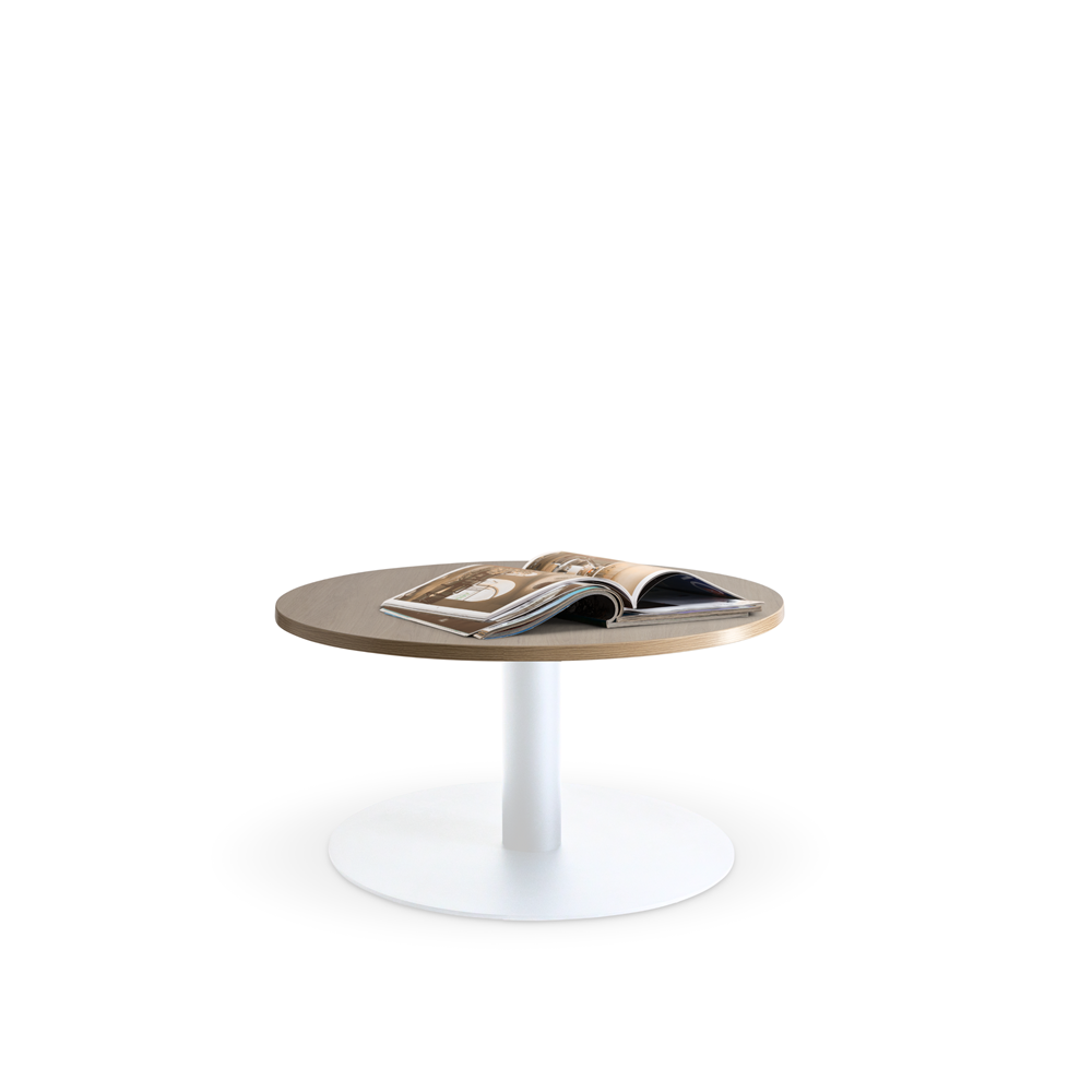 The Lunar 600 Coffee Table by Home Office Space NZ features a light wooden, durable melamine top and a white pedestal base. An open magazine with photos and text graces the tabletop. The minimalistic, white background highlights the table's customizable simplicity and elegance.